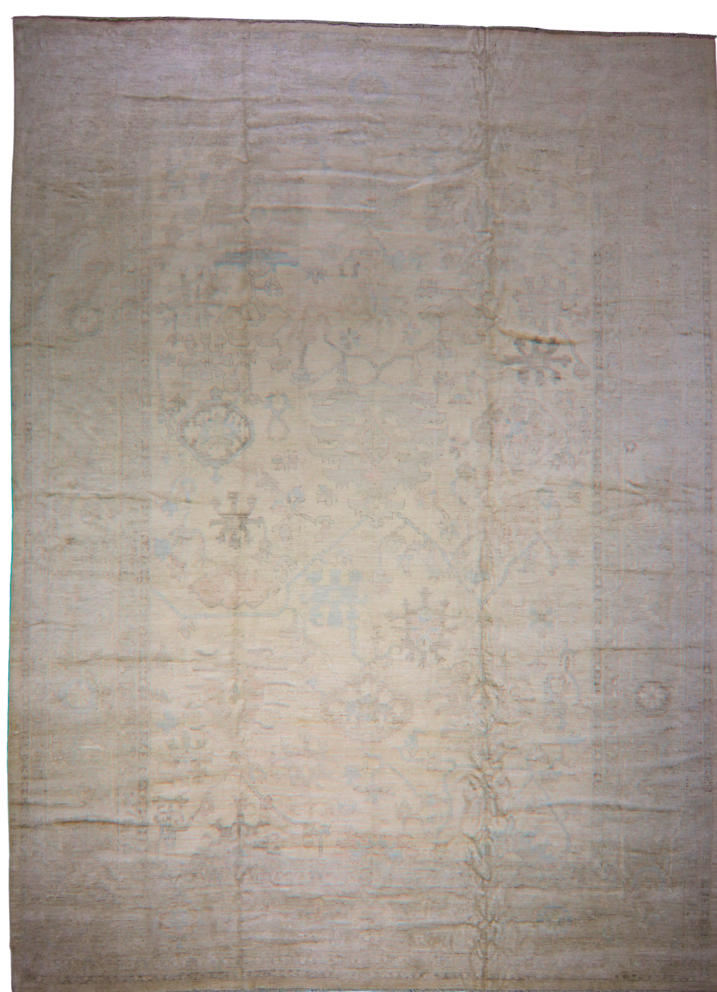 Beige area rug with subtle patterns on a plain background