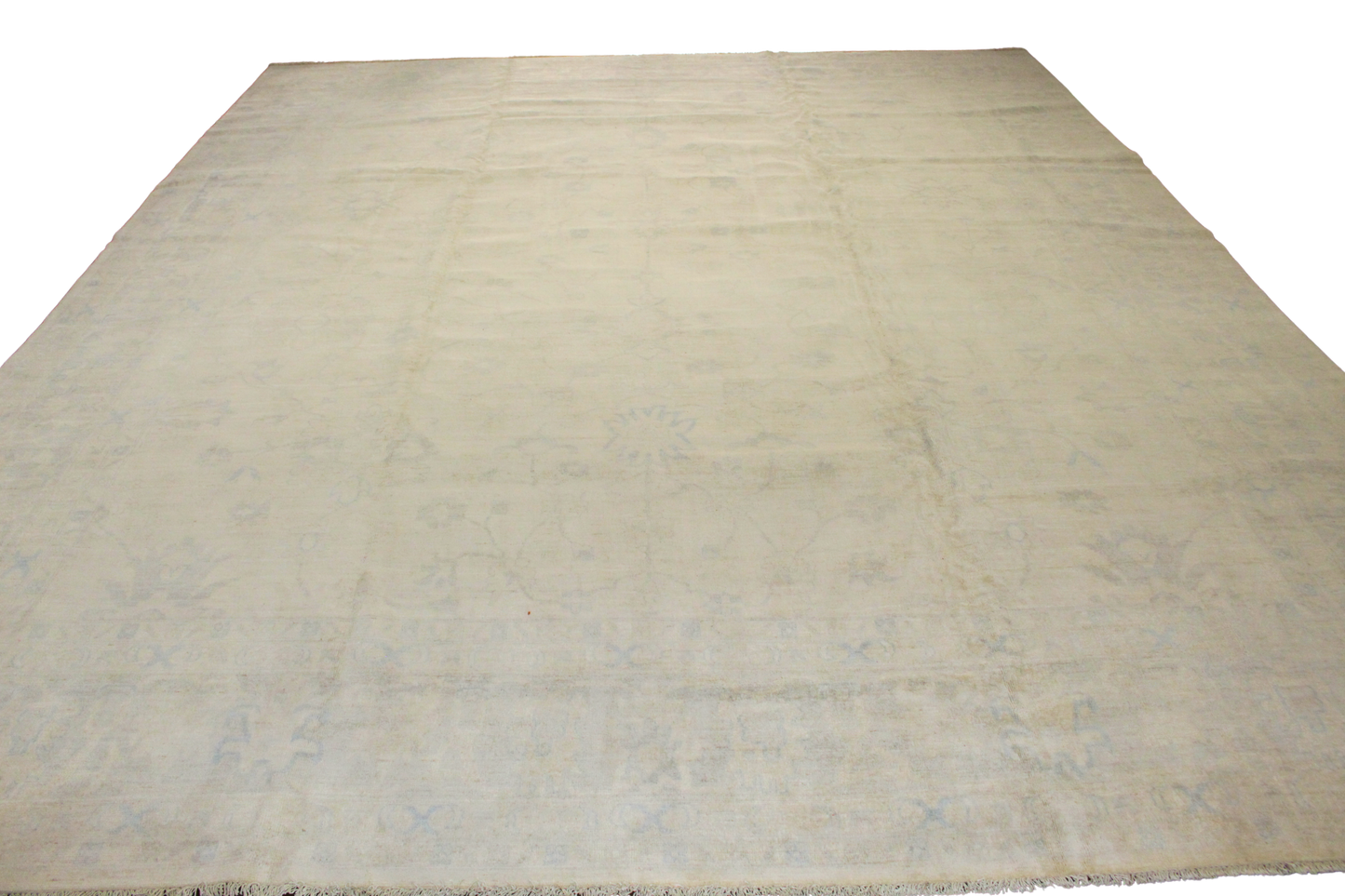 Beige rug with a subtle pattern on a white background