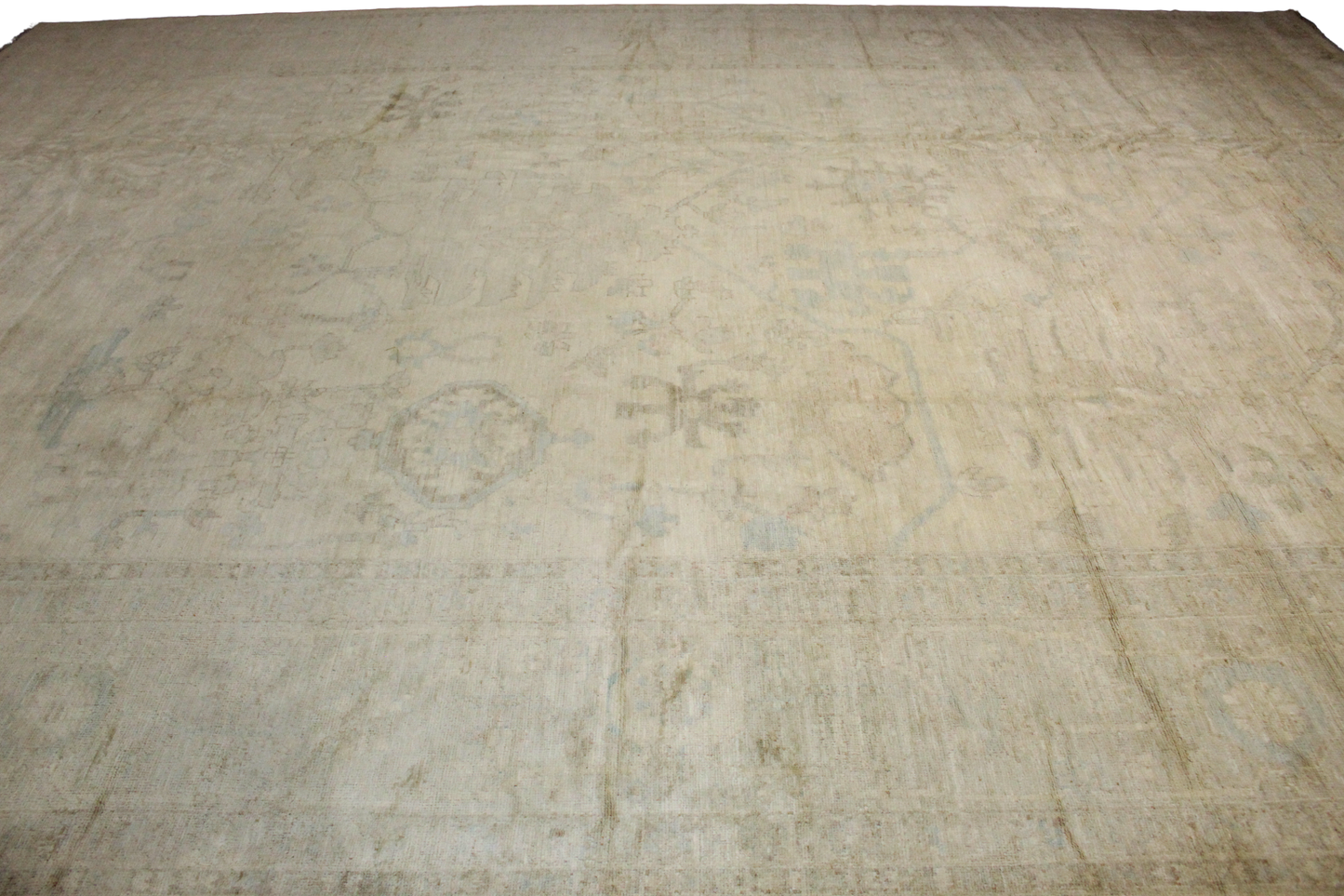 Beige rug with a textured pattern on a plain background