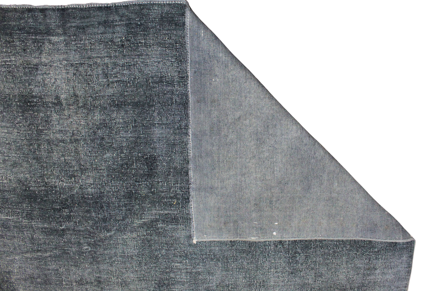 Gray textured rug corner on a white background