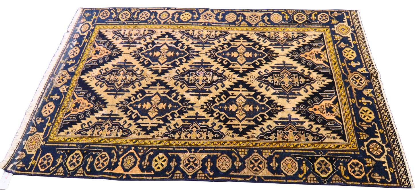antique Persian accent rug with soft peach tones

